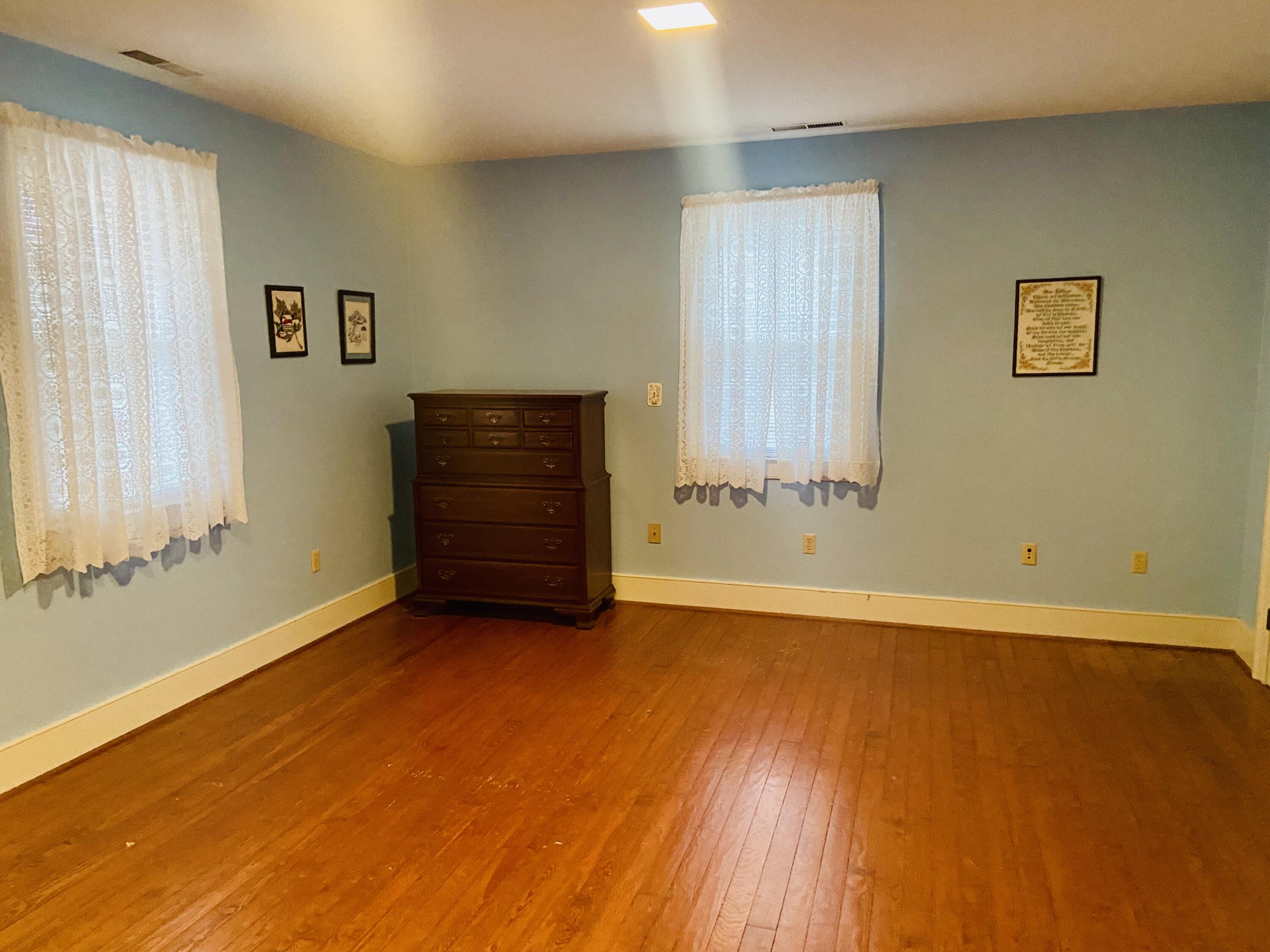 7229 Springwood Road Buchanan, VA 24066 - Photo 22 of 40 a view of an empty room with wooden floor and a window