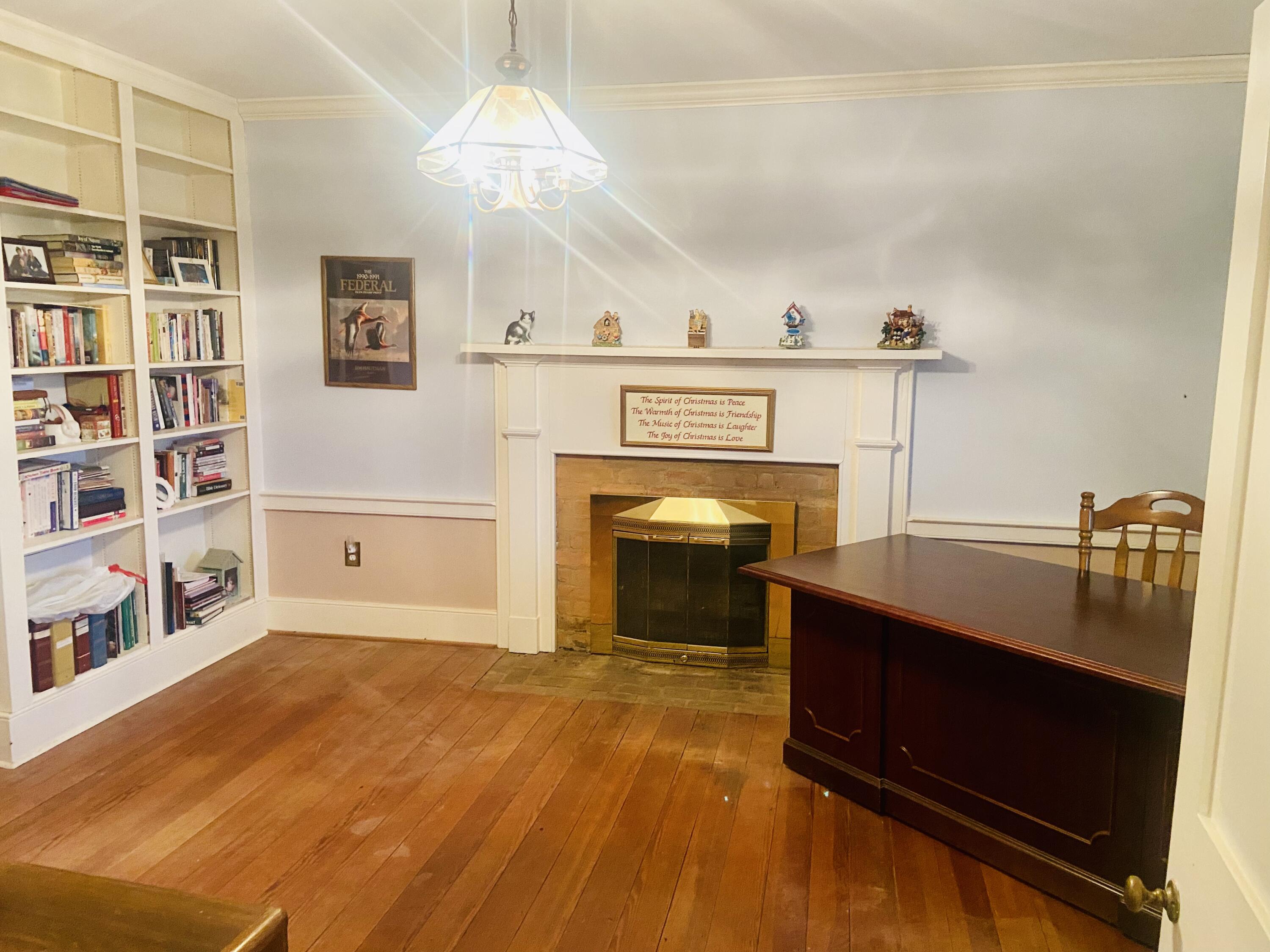 7229 Springwood Road Buchanan, VA 24066 - Photo 28 of 40 a living room with a fireplace furniture and a book shelf