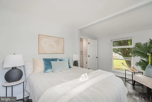 a bedroom with a bed and a painting on the wall