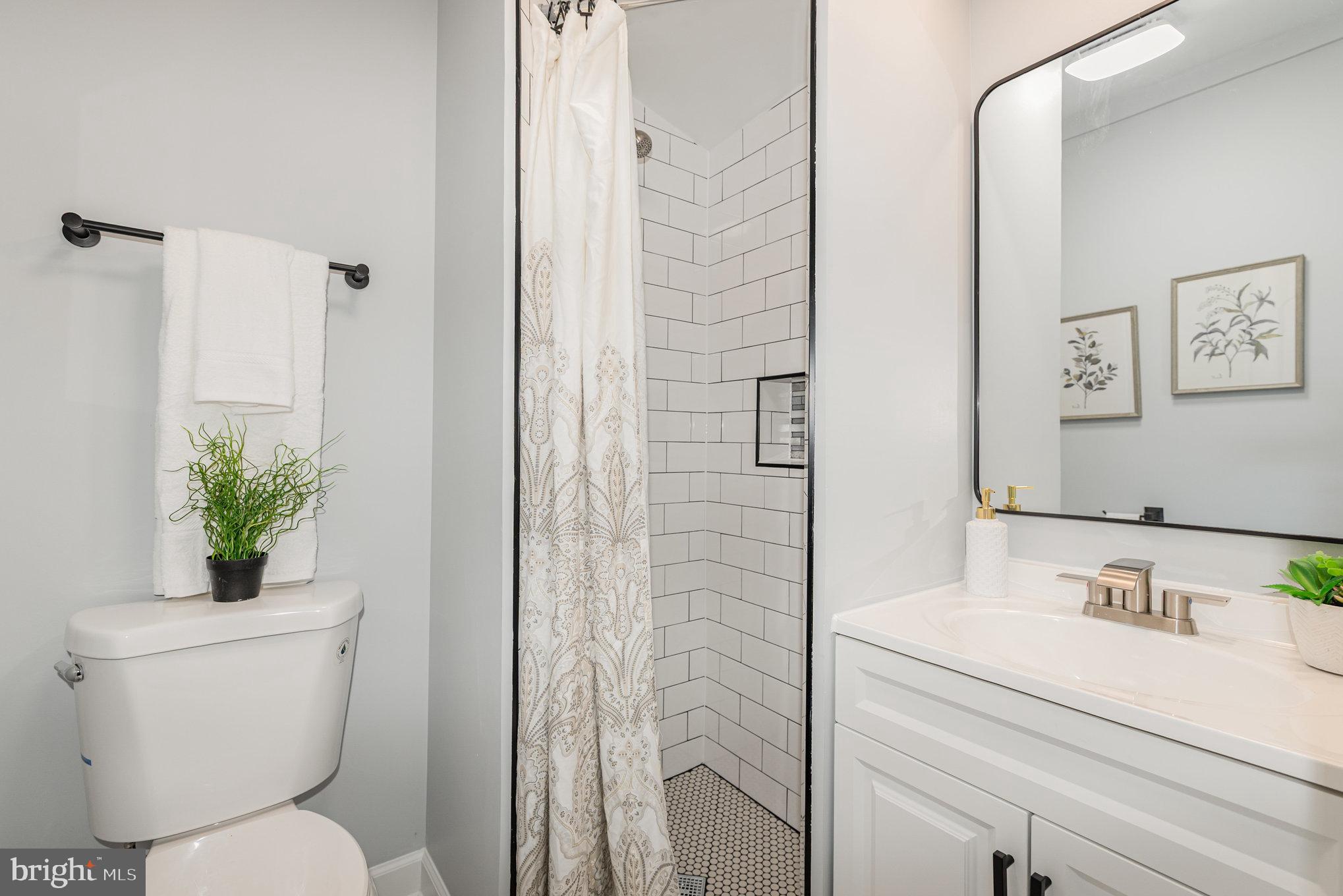 1205 North Point Road Dundalk, MD 21222 - Photo 15 of 19 a bathroom with a sink toilet and shower
