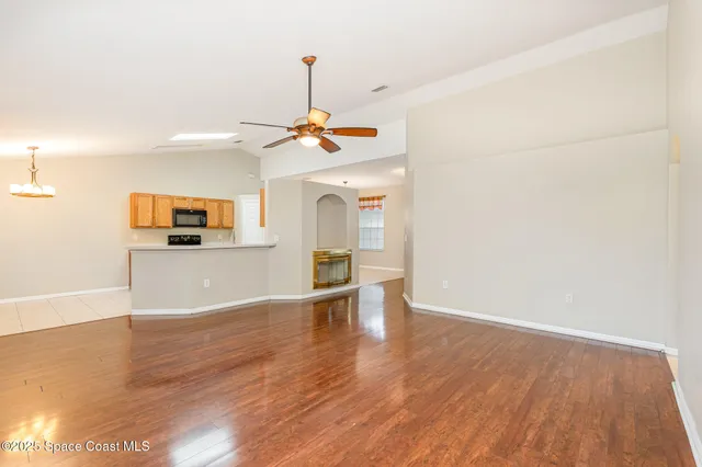 a view of a kitchen with a sink and dishwasher wooden floor