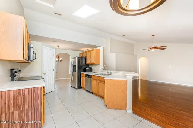 a kitchen with a sink refrigerator and cabinets