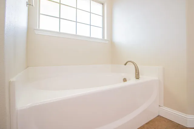 a white bath tub sitting next to a window