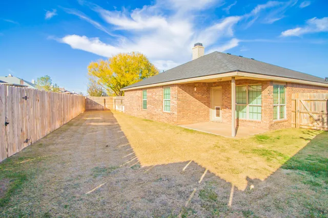 a view of a swimming pool with a yard