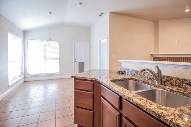 a kitchen with a sink cabinets and window
