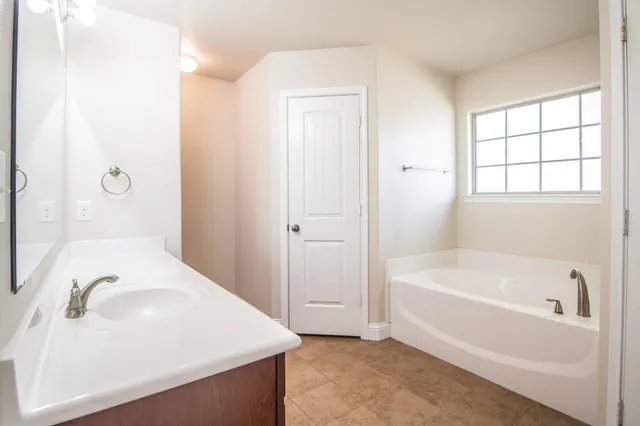 a bathroom with a bathtub and a sink