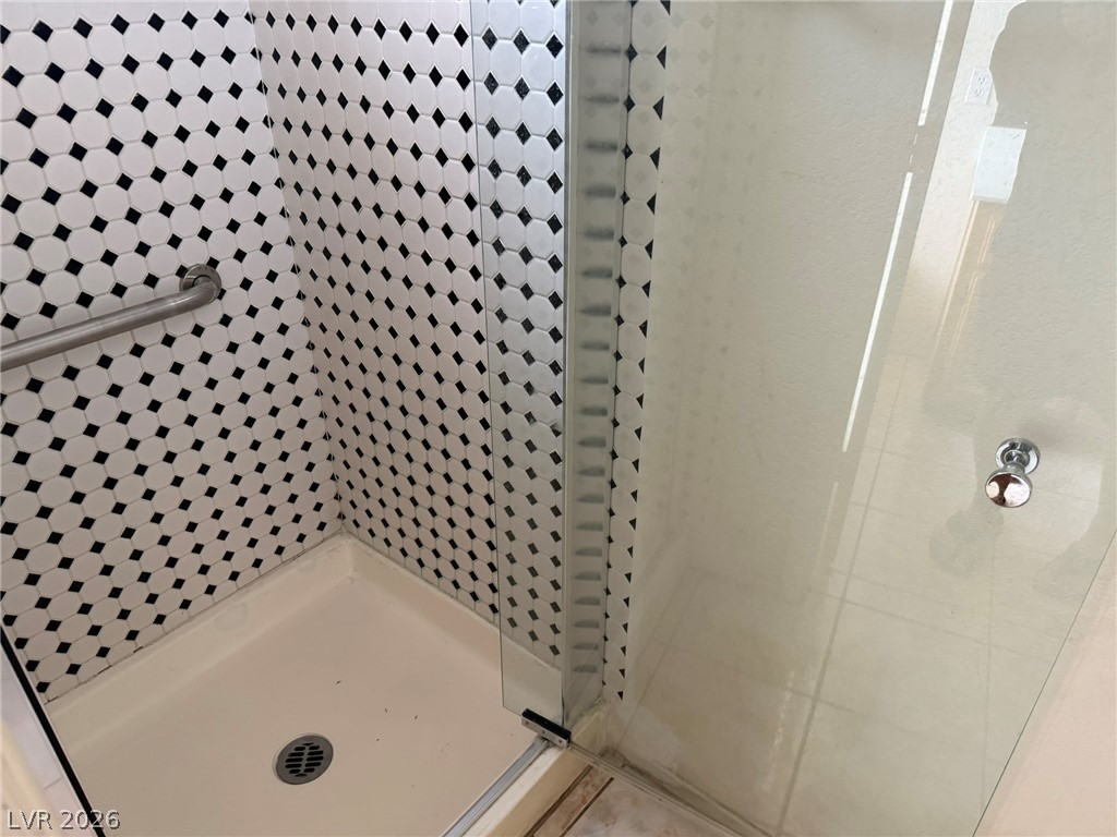 277 Gentle Bay Avenue Henderson, NV 89074 - Photo 29 of 43 This modern shower features elegant tile work and a sleek glass enclosure.