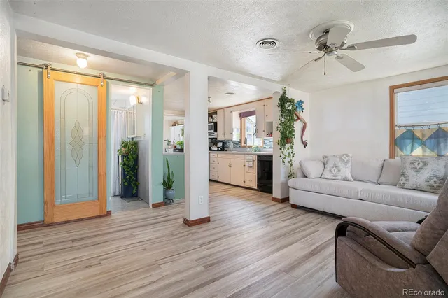a living room with furniture and a wooden floor