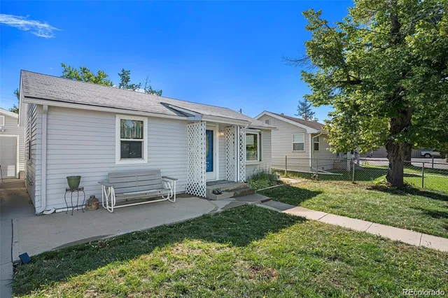a view of a house with a yard and a garden