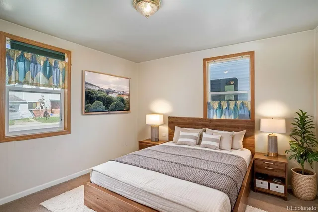 a bedroom with a bed and a painting on the wall