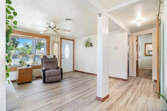 a view of a livingroom with furniture wooden floor and windows