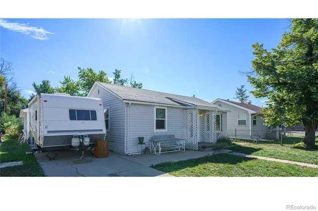 a backyard of a house with table and chairs