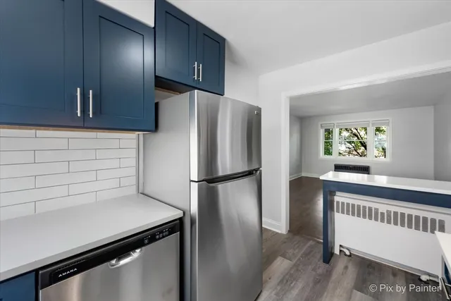 a kitchen with stove and cabinets