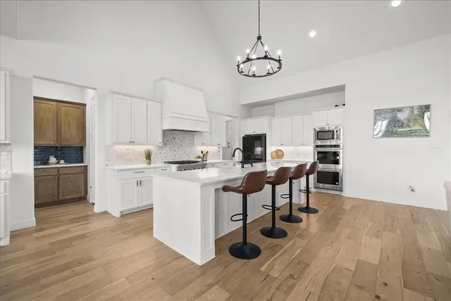 a view of kitchen with cabinets and wooden floor