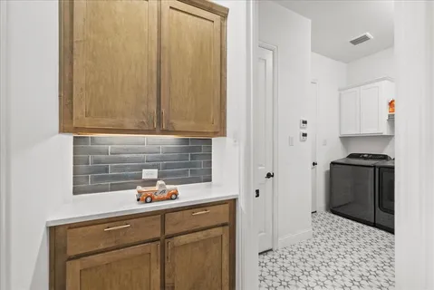 a kitchen with granite countertop a sink cabinets and stainless steel appliances