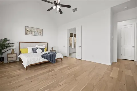 a bedroom with a bed and ceiling fan