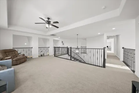 a view of a livingroom with furniture and a ceiling fan