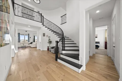 a view of a hallway with wooden floor and entryway
