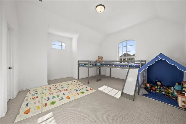 a bed sitting in a bedroom next to a window