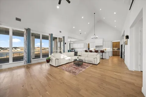 a living room with furniture and a wooden floor