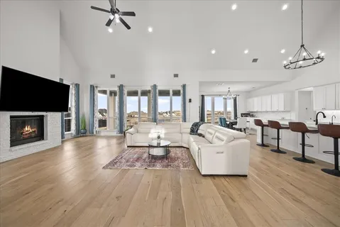 a living room with furniture a flat screen tv and a fireplace