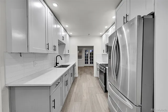 a kitchen with refrigerator a sink and dishwasher