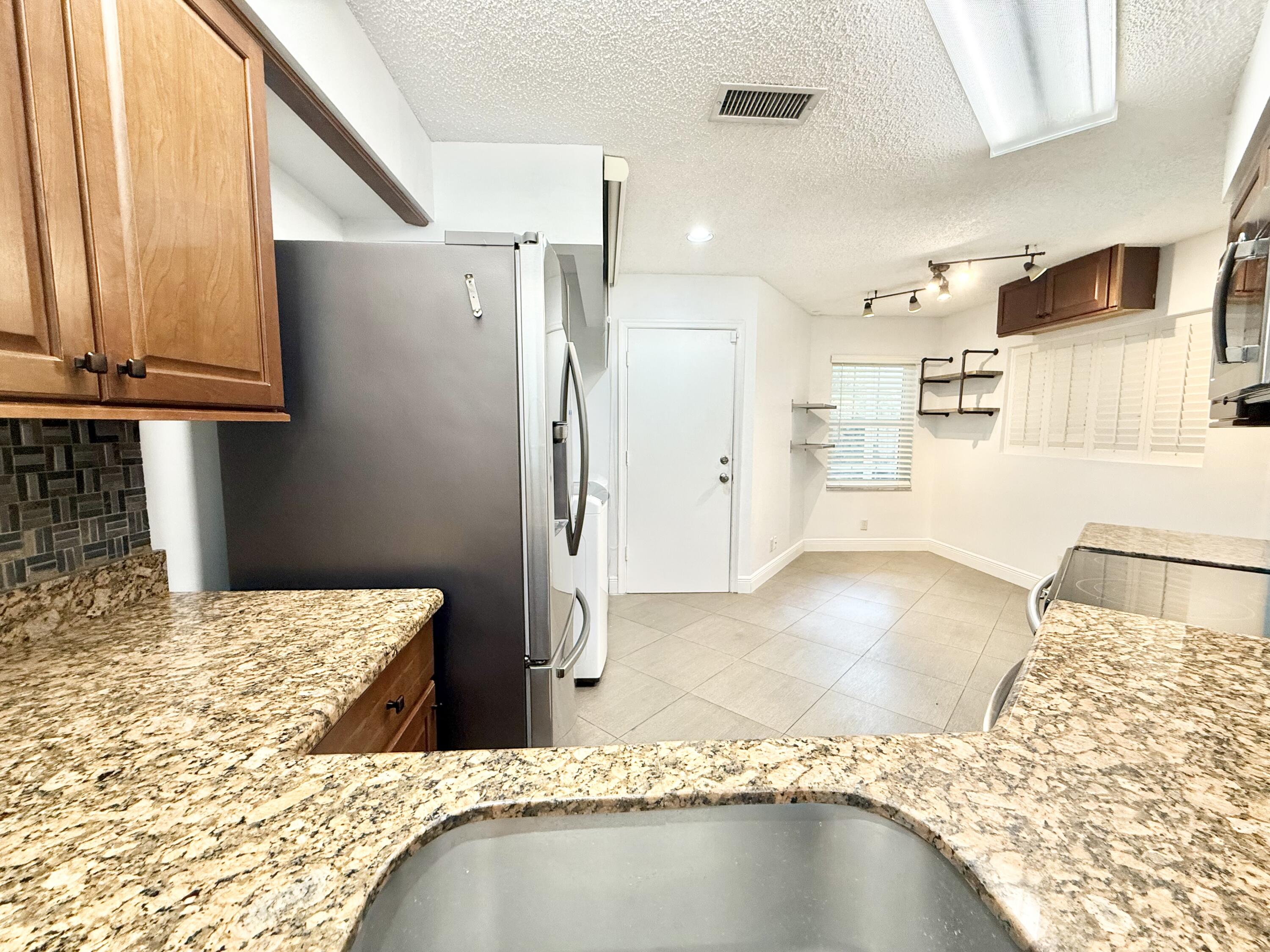 9190 Boca Gardens Parkway, Unit B Boca Raton, FL 33496 - Photo 15 of 35 a bathroom with a tub and shower
