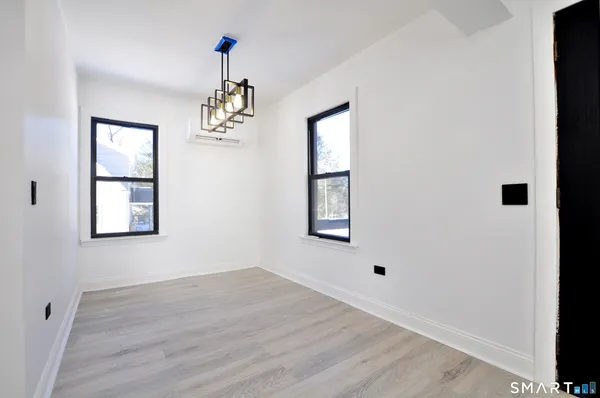 an empty room with windows and cabinet