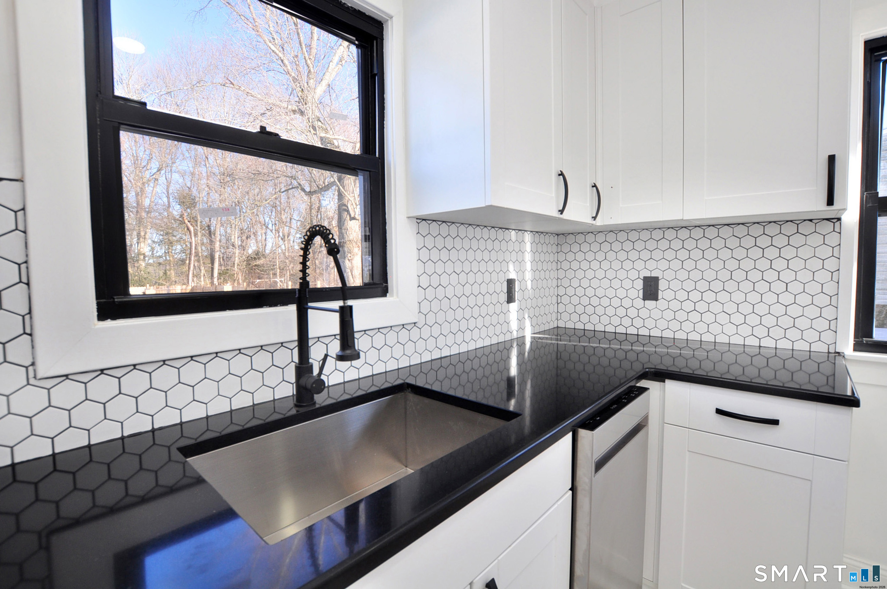 443 Todd Road Wolcott, CT 06716 - Photo 30 of 41 a view of a kitchen with a sink and a large window