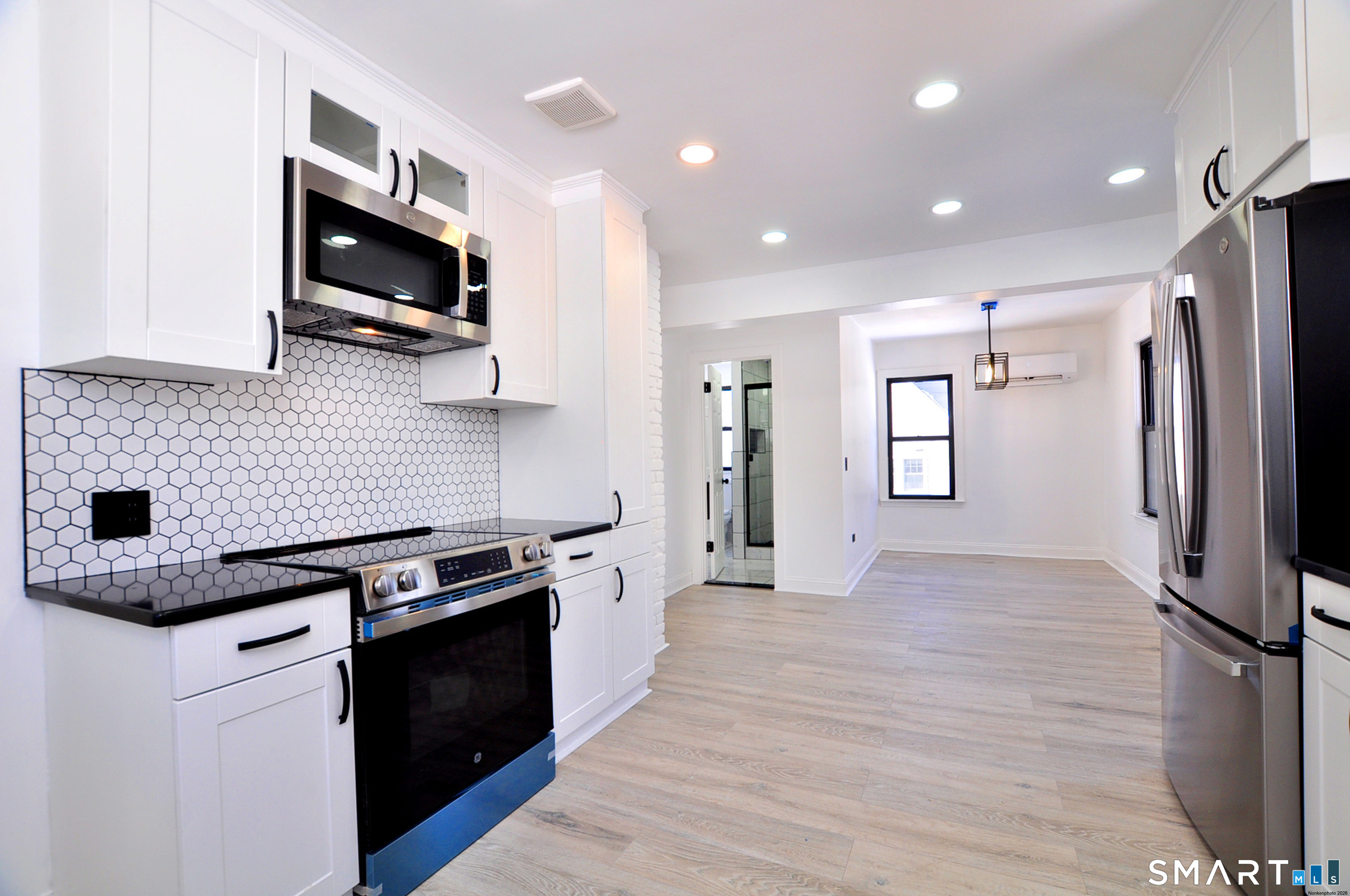 443 Todd Road Wolcott, CT 06716 - Photo 31 of 41 a kitchen with granite countertop a refrigerator stove and microwave