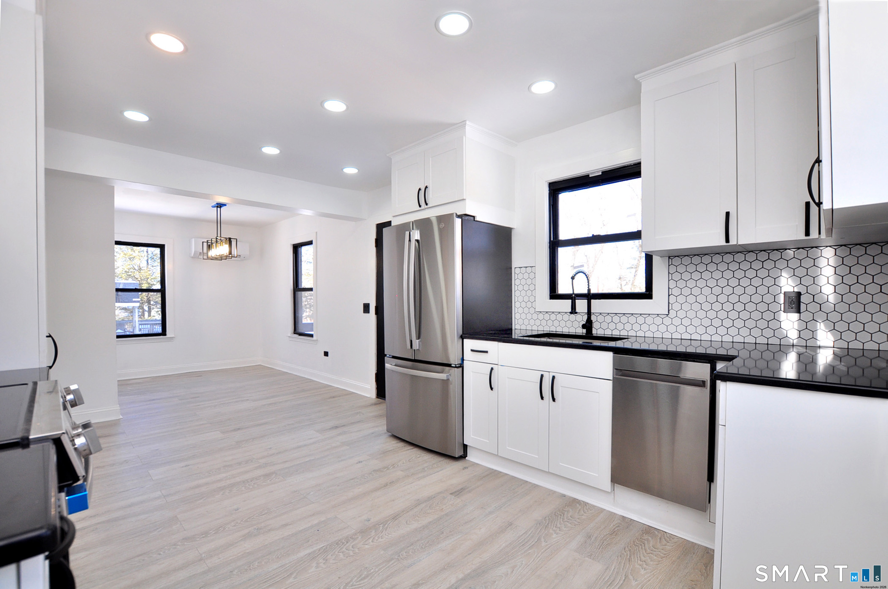 443 Todd Road Wolcott, CT 06716 - Photo 32 of 41 a kitchen with stainless steel appliances granite countertop a refrigerator a sink dishwasher a stove and white cabinets with wooden floor