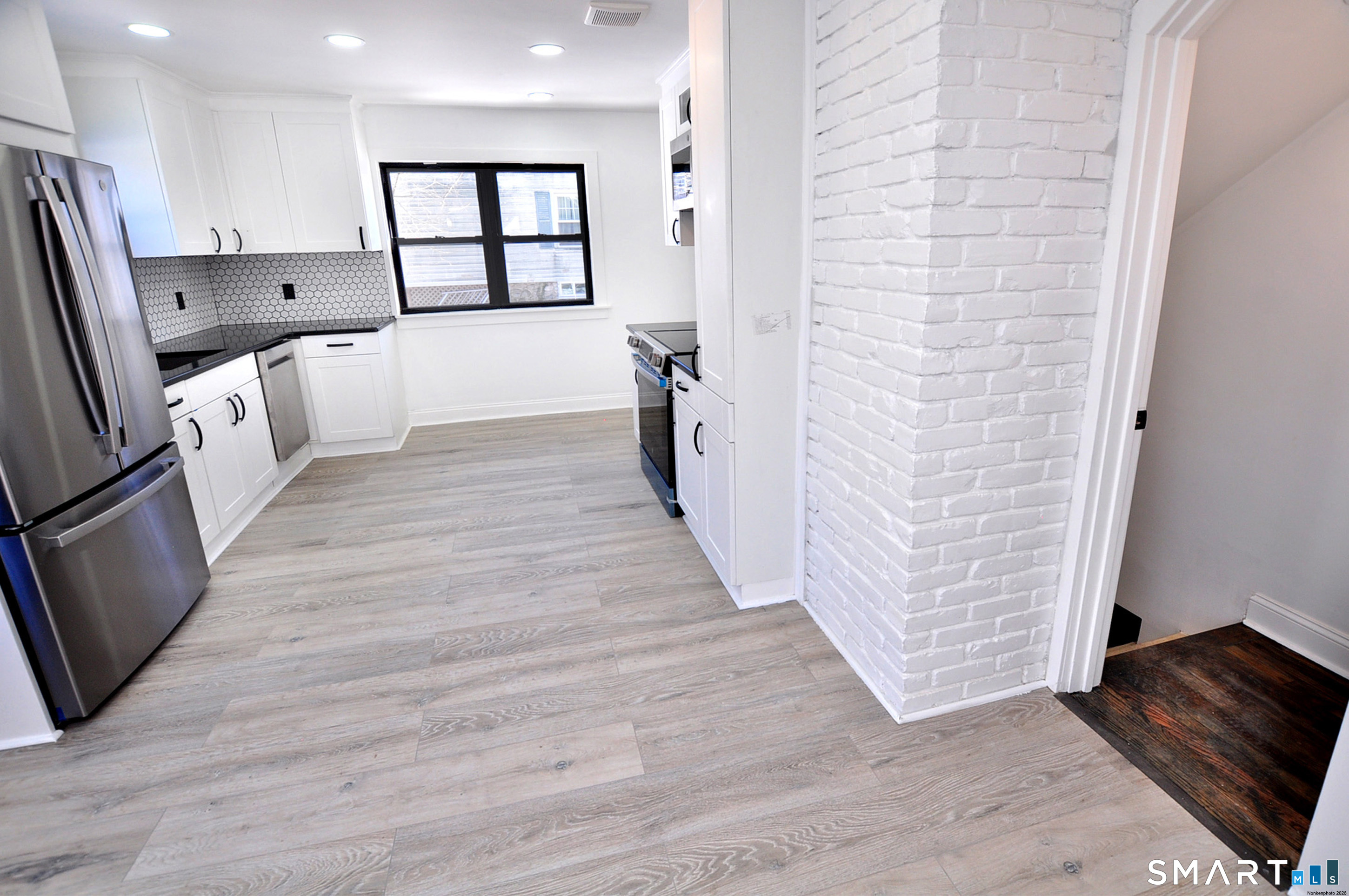 443 Todd Road Wolcott, CT 06716 - Photo 34 of 41 a view of kitchen with stainless steel appliances wooden floor and window