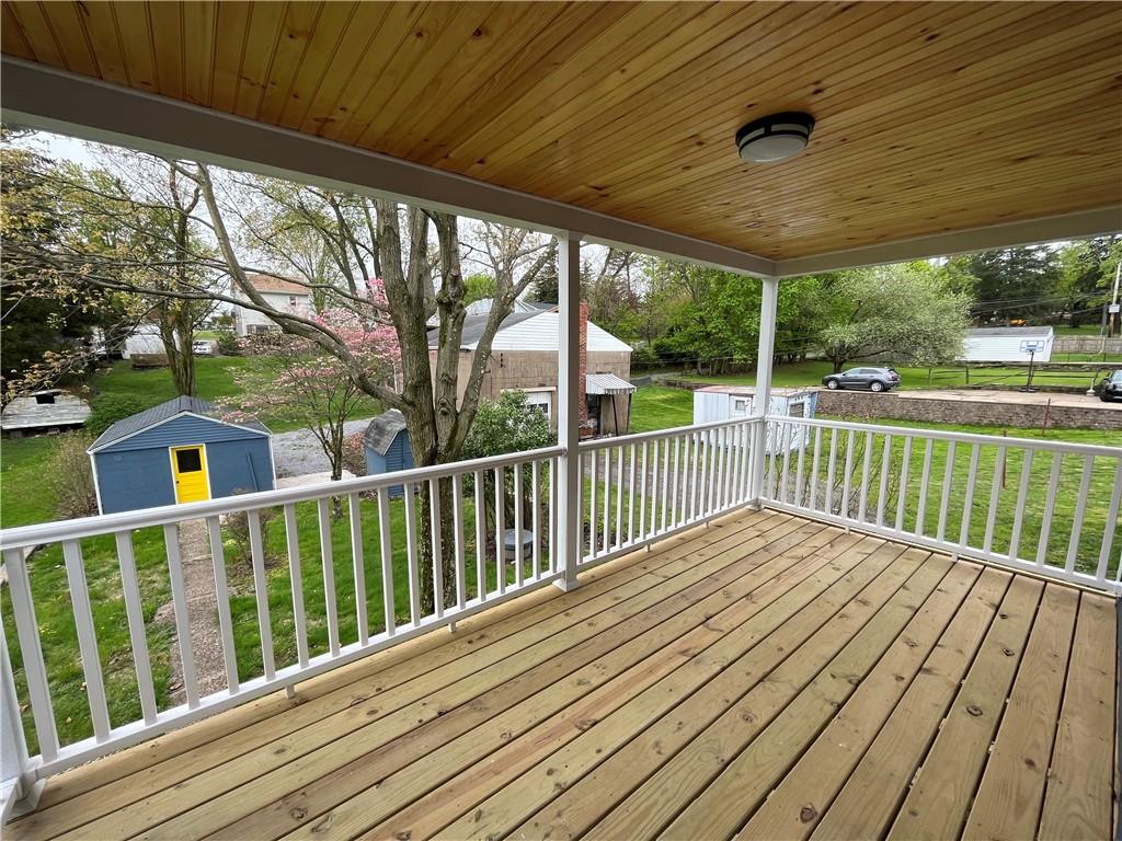 a view of backyard with a deck and wooden floor