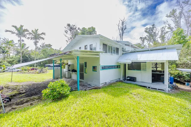 a view of a house with a yard porch and furniture