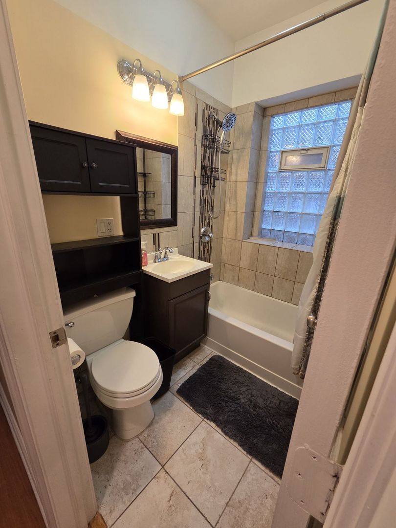 5902 West Madison Street, Unit 3 Chicago, IL 60644 - Photo 11 of 18 a bathroom with a toilet a sink and bathtub