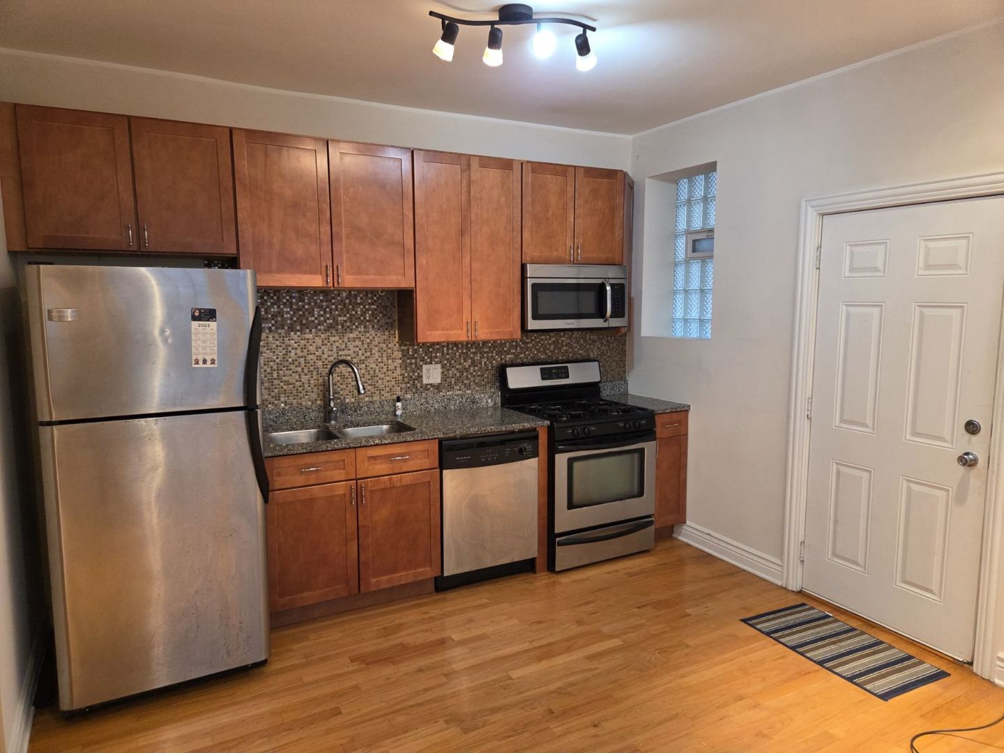 5902 West Madison Street, Unit 3 Chicago, IL 60644 - Photo 17 of 18 a kitchen with a refrigerator sink and microwave