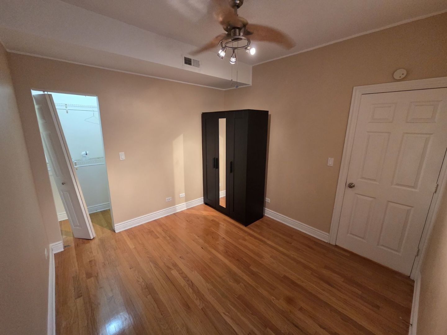 5902 West Madison Street, Unit 3 Chicago, IL 60644 - Photo 10 of 18 wooden floor in an empty room with a window