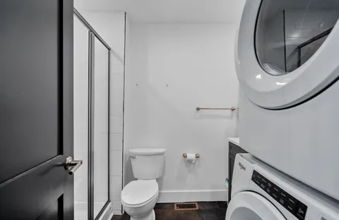 a bathroom with a toilet a sink and a mirror