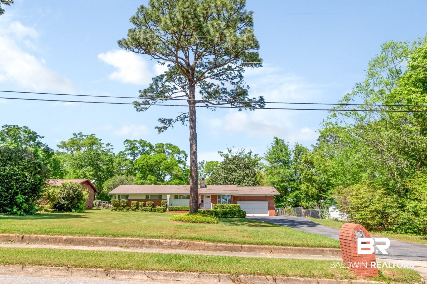 6300 Woodcrest Drive Mobile, AL 36608 - Photo 25 of 35 Ranch-style home with a front lawn, a garage, and aphalt driveway