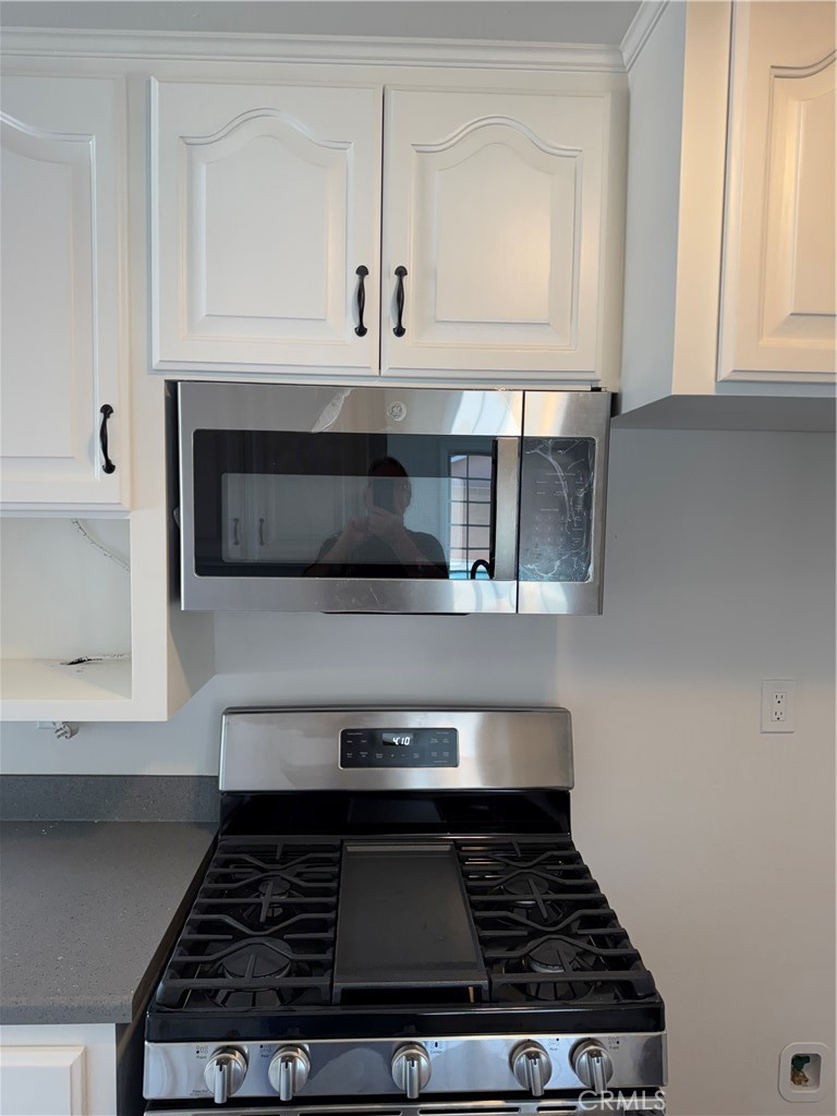 5781 Lime Avenue Cypress, CA 90630 - Photo 12 of 40 a stove top oven sitting inside of a kitchen