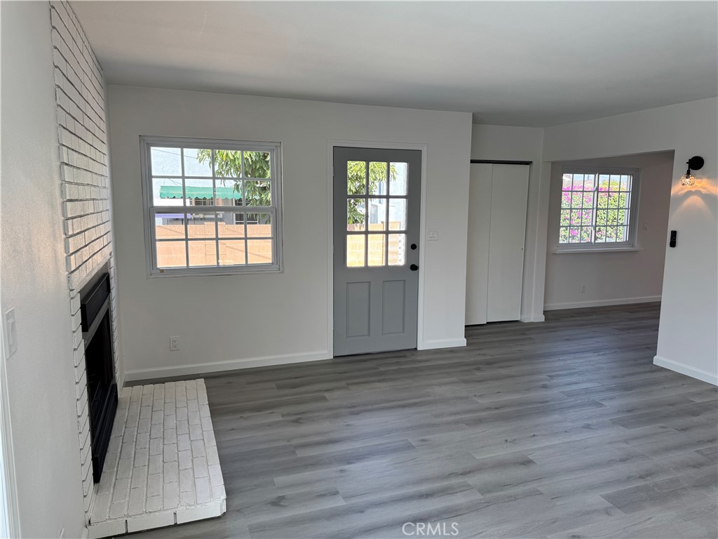 5781 Lime Avenue Cypress, CA 90630 - Photo 20 of 40 an empty room with wooden floor and windows