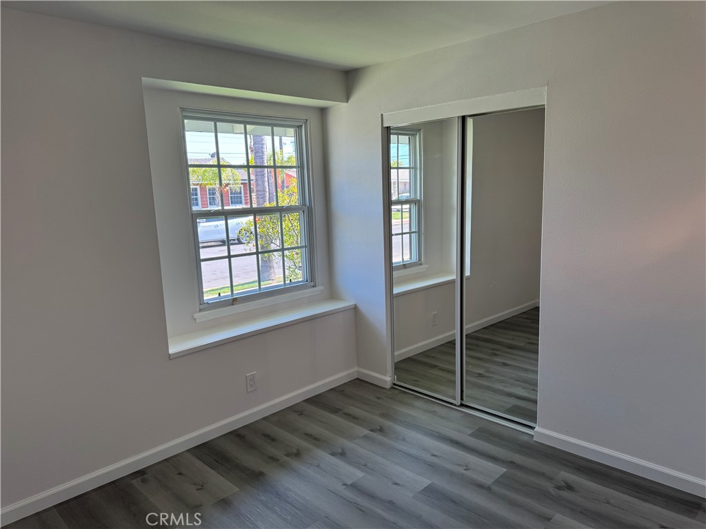 5781 Lime Avenue Cypress, CA 90630 - Photo 23 of 40 an empty room with wooden floor and windows