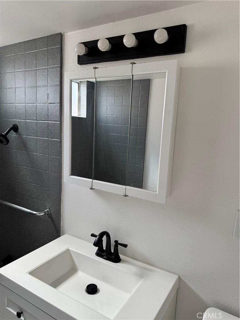 5781 Lime Avenue Cypress, CA 90630 - Photo 28 of 40 a bathroom with a sink and mirror