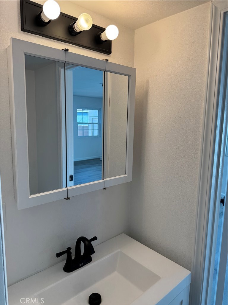 5781 Lime Avenue Cypress, CA 90630 - Photo 31 of 40 a bathroom with a sink and a mirror
