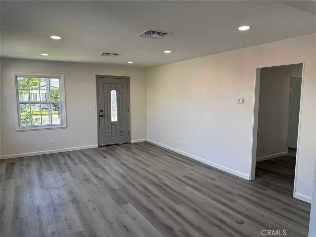 5781 Lime Avenue Cypress, CA 90630 - Photo 5 of 40 an empty room with wooden floor and windows