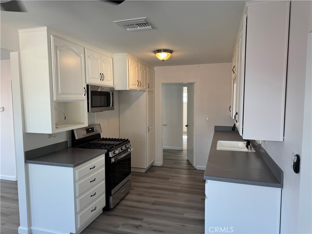 5781 Lime Avenue Cypress, CA 90630 - Photo 9 of 40 a kitchen with a sink stove and refrigerator