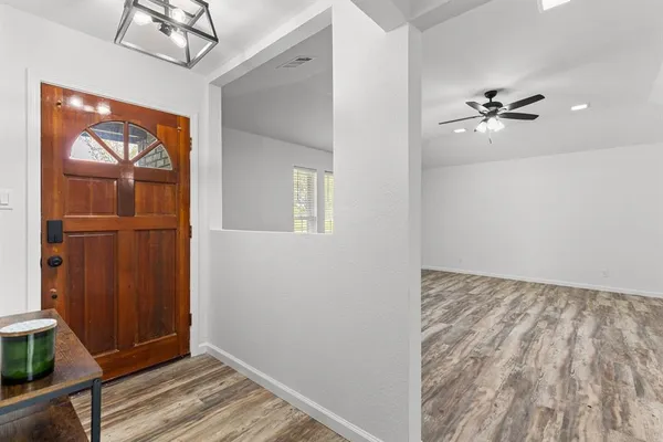 wooden floor in an empty room with a window