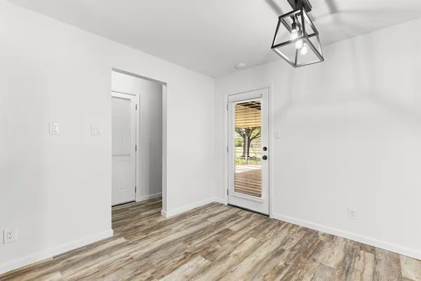 a view of a room with wooden floor and windows