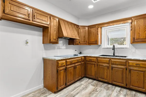 a kitchen with stainless steel appliances granite countertop a sink stove and cabinets