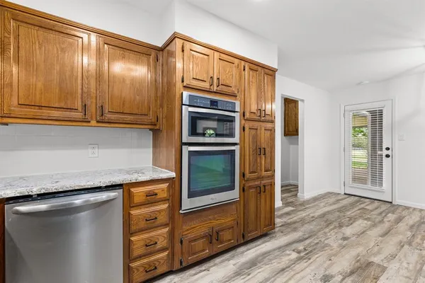 a kitchen with granite countertop stainless steel appliances and counter space